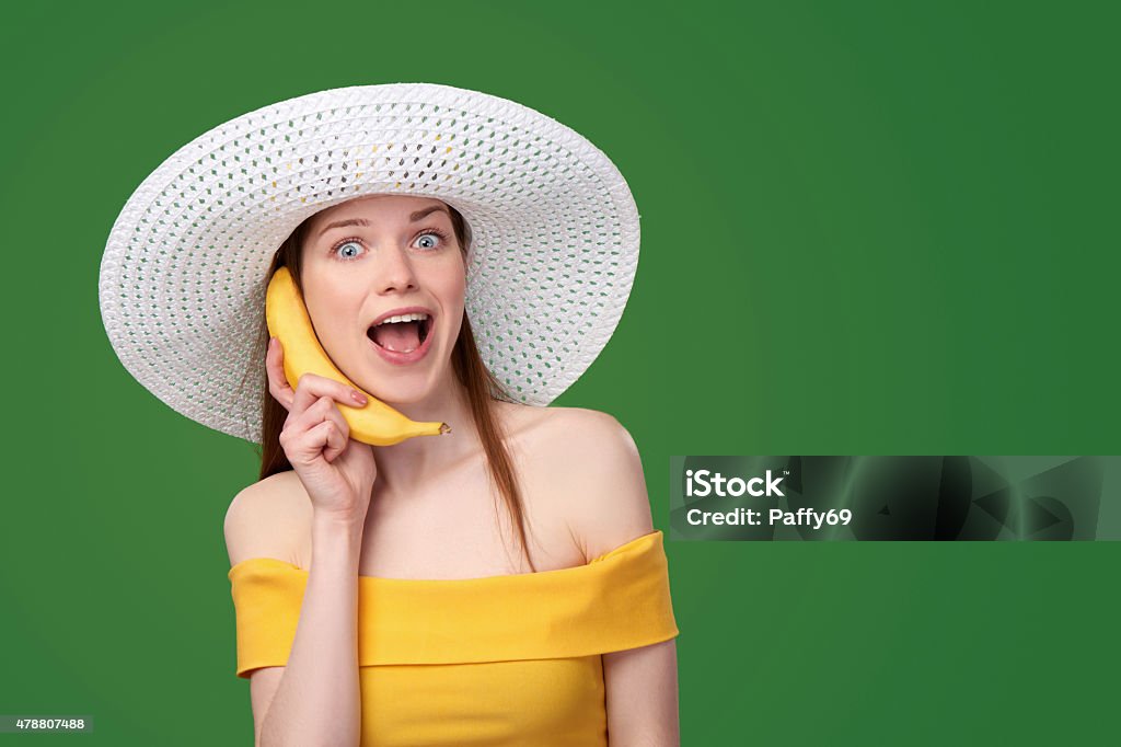 Banana phone Surprised summer style woman holding a banana as a telephone 2015 Stock Photo