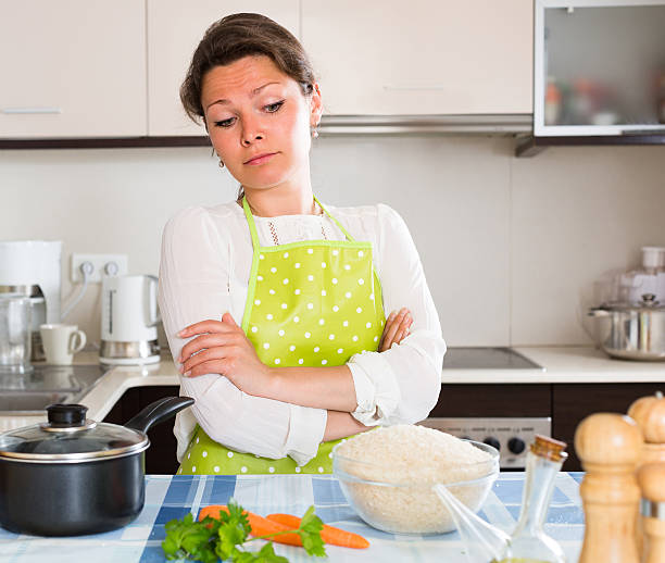 istock Sad woman cooking rice in the kitchen 478808044