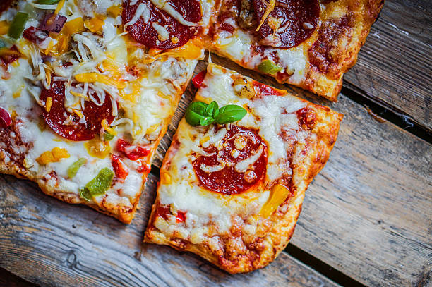 istock Square pepperoni pizza on rustic wooden background 478809743