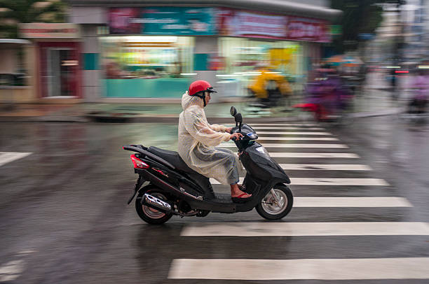 Street in Vietnam. A bright bus, cars, a woman on a bicycle, pedestrians. Real life in Asia