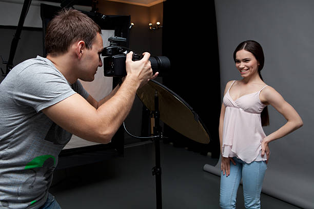 istock Photographer at work with model in the professional studio 478811690