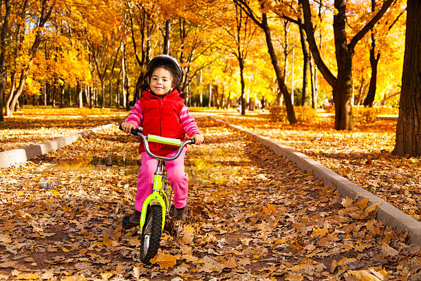 istock Girl riding bicycle on autumn rode 478811953