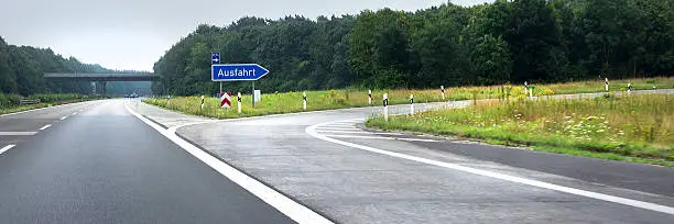 German empty highway exit with a flyover in the distance