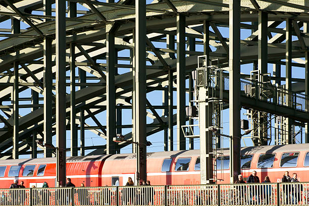 Cologne, Germany - February 02, 2014: People and a train going over the Hohenzollern Bridge and crossing the Rhine on February 02, 2014 in Cologne.