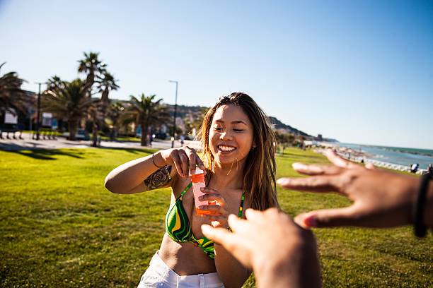 Teens playing with bubbles at the park Group of only woman teenagers having fun at the park playing and relaxing. hot filipina women stock pictures, royalty-free photos & images