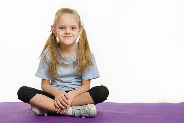 istock Six year old girl sitting on the mat for practice 478815934