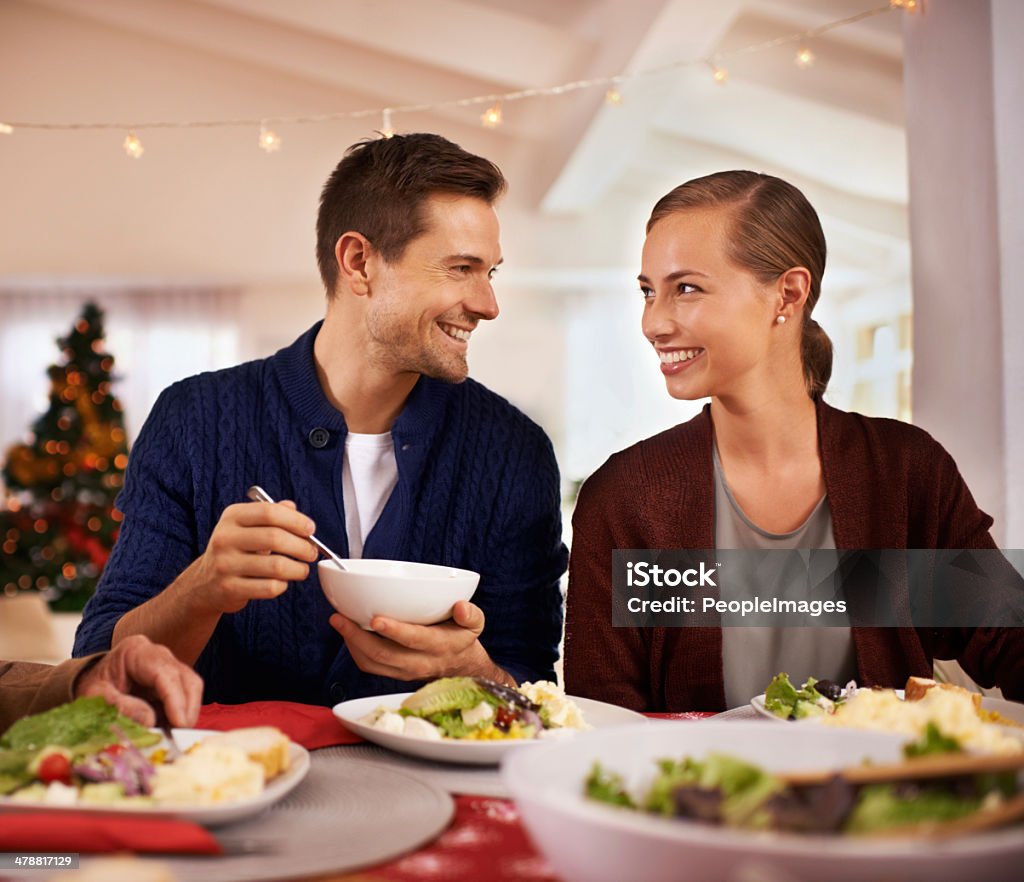 What a delicious Christmas dinner you made! Shot of a happy young couple eating Christmas dinner Adult Stock Photo