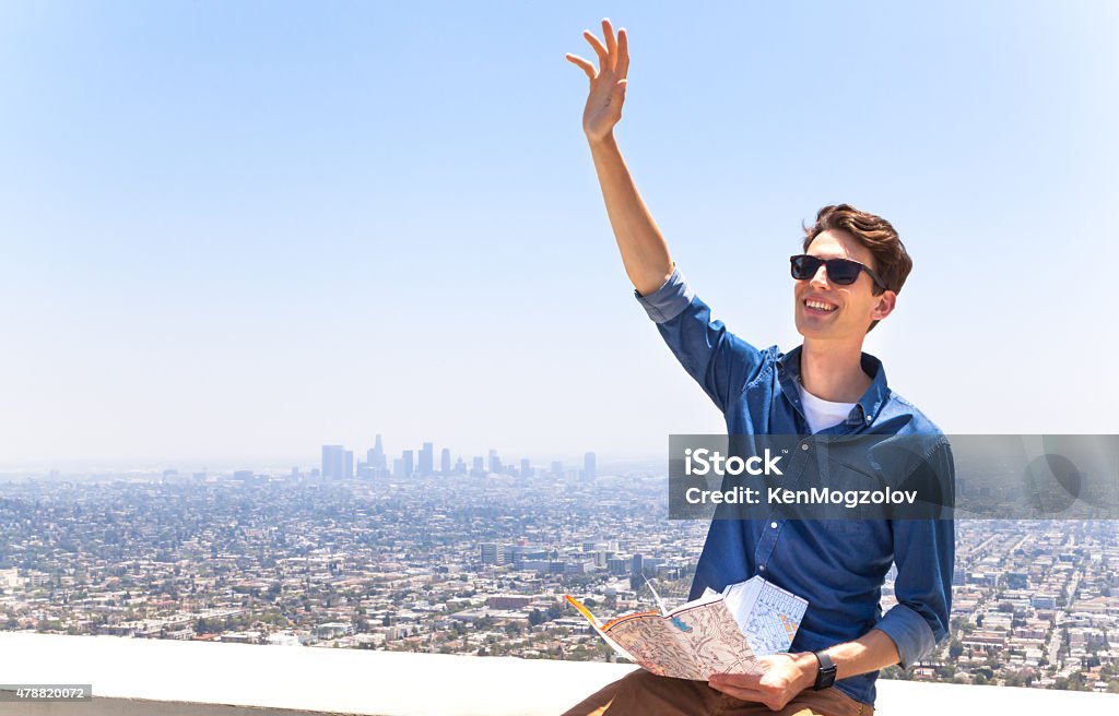 Tourist in Los Angeles Dmitry Korikov as a tourist with a map. View on downtown of Los Angeles from Griffith Observatory Park. 2015 Stock Photo