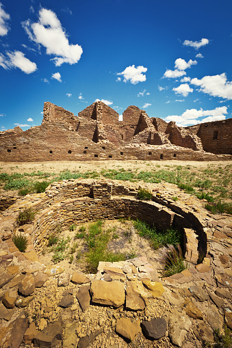 The Kiva, a spiritual site in The Chaco Culture National Historical Park in New Mexico. A famous ancient Pueblo site featuring architectural ruins of homes, food storages, spiritual kivas and villages built in the ancient adobe style architecture. Photographed on location in Pueblo Casa Rinconada in the National Park in vertical format.