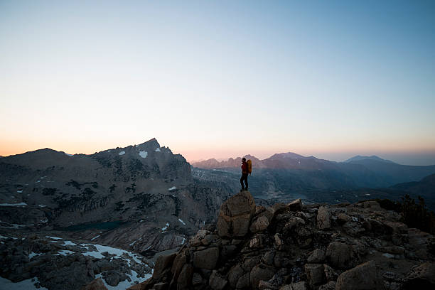 high sierra Strong hiker in the mountains watching the sunset  trailblazing stock pictures, royalty-free photos & images