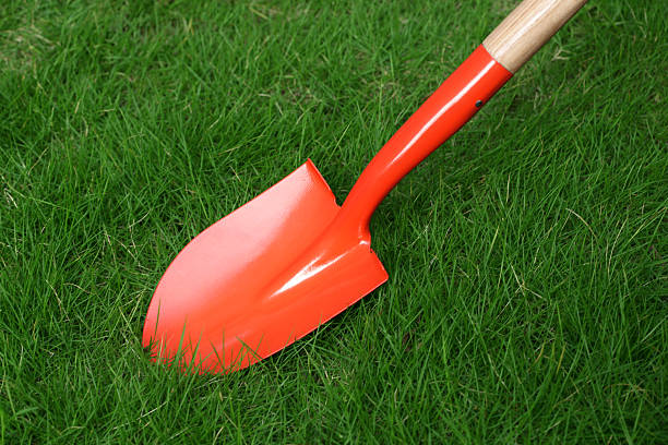 istock New dirt shovel on grassland 478821704