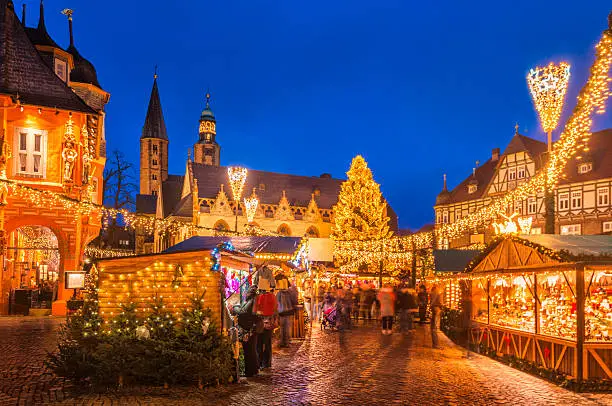 The traditional Christmas Market on the historic Market Square of Goslar, Germany at dusk. 