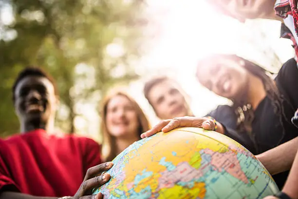 Photo of teenagers college student smiling with globe