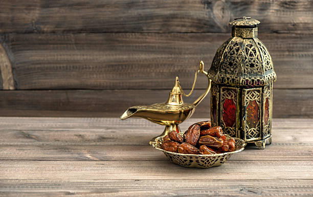 Ramadan lamp and dates on wooden background. Oriental lantern stock photo