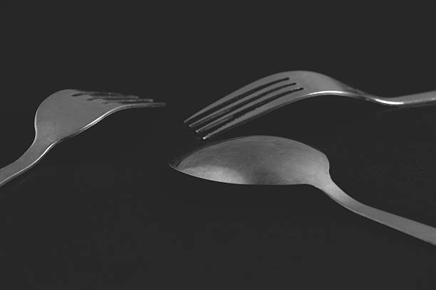 istock Cutlery set - two forks and spoon on black background 478830644