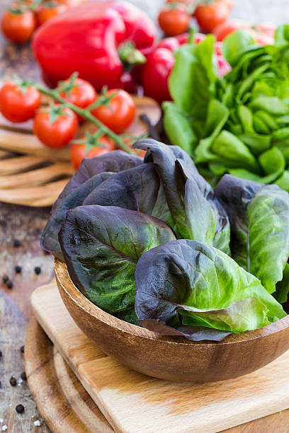 istock Lettuce oak with tomatoes and paprika on a wooden surface 478831579