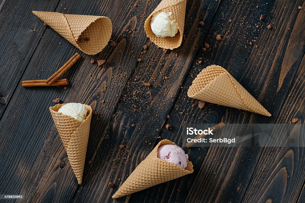 Ice Cream Ice Cream  in waffle cone on vintage wooden table. 2015 Stock Photo
