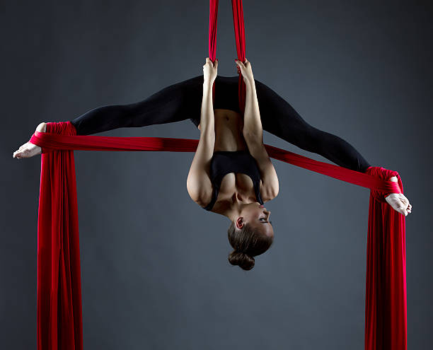 istock Sexy female acrobat performs hanging upside down 478835250