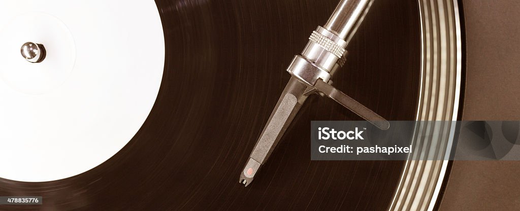 Dj needle stylus on spinning record Dj needle stylus on spinning record, closeup 2015 Stock Photo