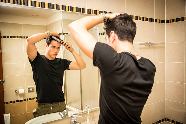 istock Reflection of Man Bushing Hair in Mirror 478838034