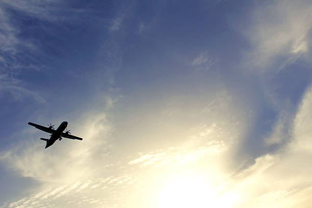 istock Silhouette of an airplane flying in the blue sky 478838310