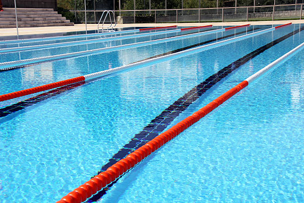 Swimming pool lane Ropes View of lane rope in an outside Olympic pool. swimming pool lane ropes stock pictures, royalty-free photos & images