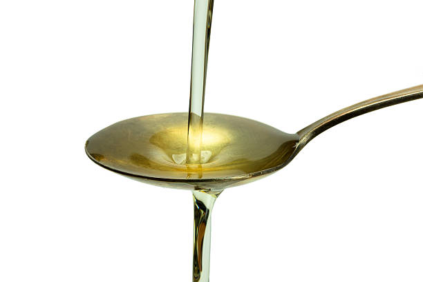 istock Oil poured into the old vintage spoon and overflows 478839266