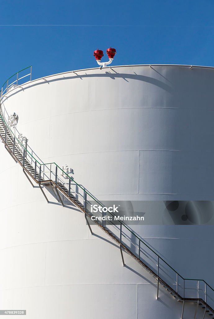 white tanks in tank farm with iron staircase white tanks in tank farm with iron staircase under blue sky 2015 Stock Photo