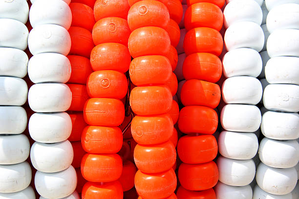Swimming pool lane Ropes Roll of white and orange swimming pool ropes. swimming pool lane ropes stock pictures, royalty-free photos & images