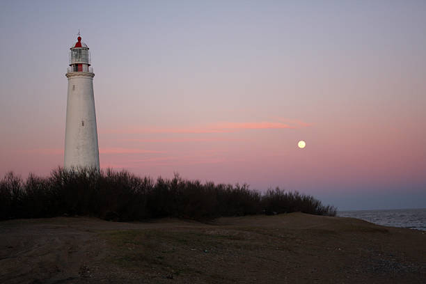 Moon and Lighthouse, La Paloma, Uruguay stock photo