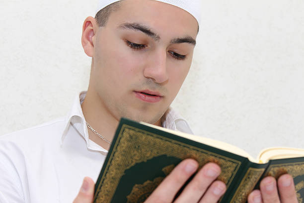 istock Young Muslim Guy Reading The Koran 478842538