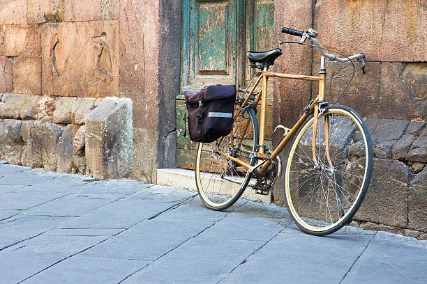 istock Yellow bicycle with bag against a stone wall 478843154