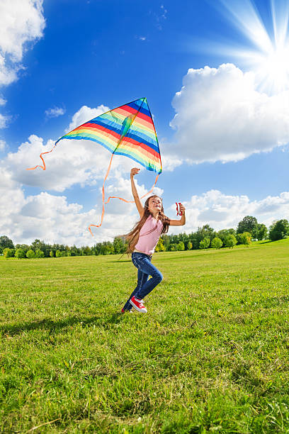 istock One little girl run with kite 478844003
