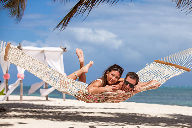 istock Romantic Couple Relaxing In Beach Hammock 478849286