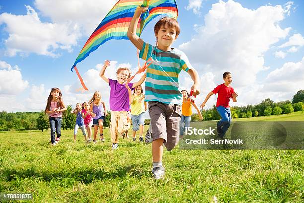 Many Kids Run With Kite Stock Photo - Download Image Now - School Children, Group Of People, Large