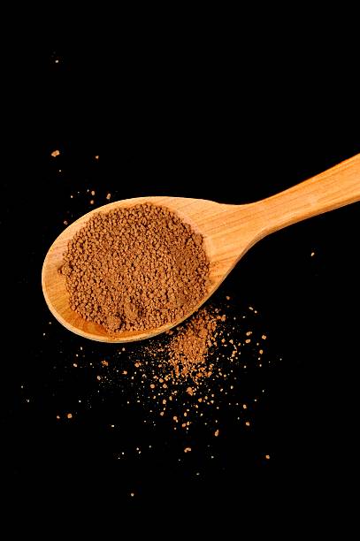 istock Wooden Spoon with Instant Cocoa Powder on Black Background 478852075
