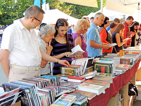 Voronezh, Russia - June 5, 2015: Buyers look through a new books on the Book Fair in city square