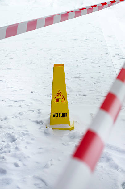 istock Yellow plastic wet floor sign on snowed floor. 478854975