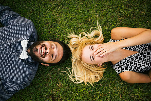 istock Happy young couple lying on grass 478855210