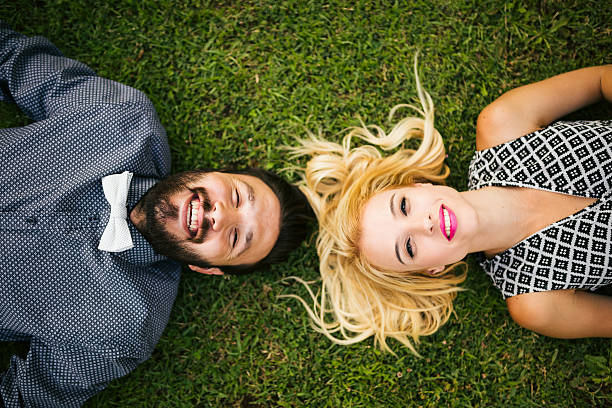 istock Happy young couple lying on grass 478855212