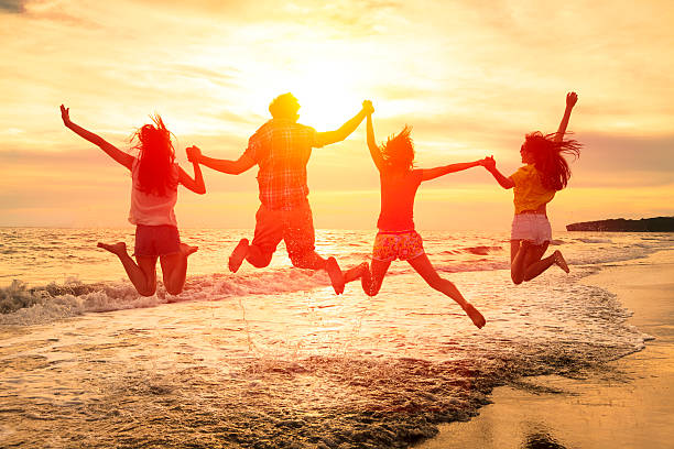 istock group of happy young people jumping on the beach 478855924