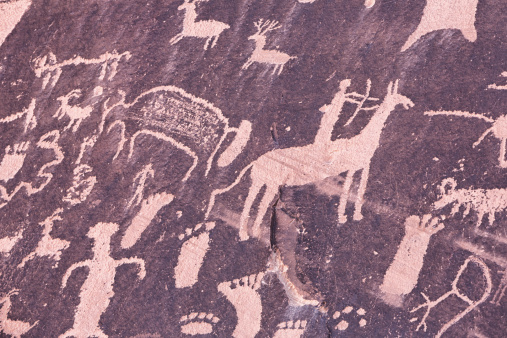 Newspaper rock is a protected wall with ancient Anasazi Indian petroglyphs