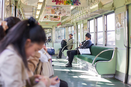 Kyoto,Japan - 27 March,2015 : businessman and business woman sitting on seat in train