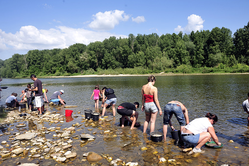 Cardet, France - May 25, 2015: Gold prospectors of all ages on the banks of the Gardon River Gard French gold coming down from the Cevennes.