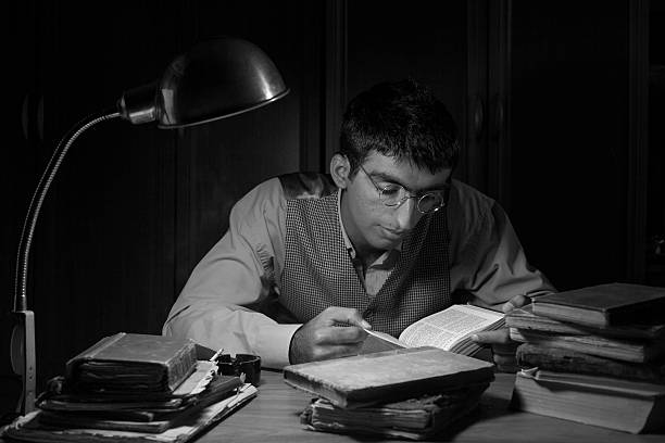 istock Adult man reading bible on table in the dark 478860497