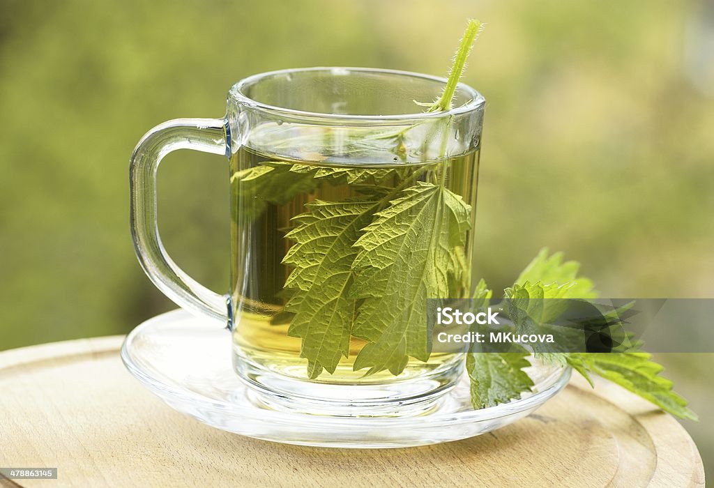 Nettle tea Nettle tea in glass. Nettle Stock Photo