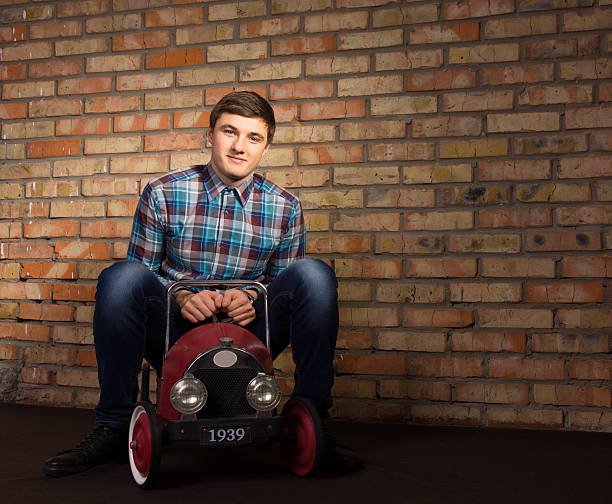 istock Young Man Playing with Toy Automobile 478863702