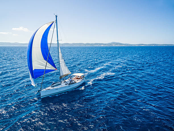 Sailing with sailboat, view from drone Sailboat during sailing. High angle view from quadcopter Phantom 3. Model released. mast sailing photos stock pictures, royalty-free photos & images