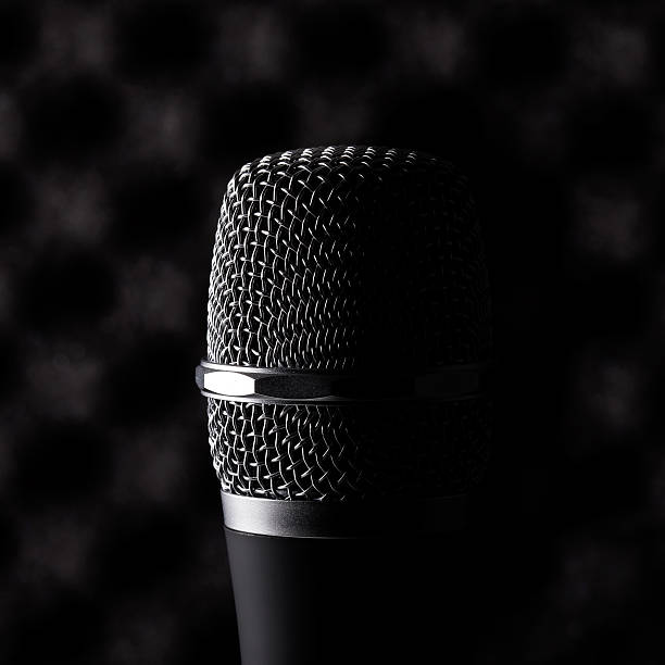 istock Wireless microphone closeup on foam acoustic background 478865350
