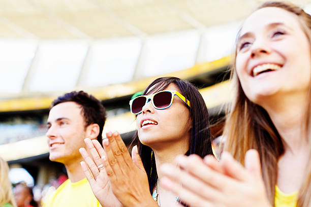 istock Clapping football fans support their team, smiling 478870315